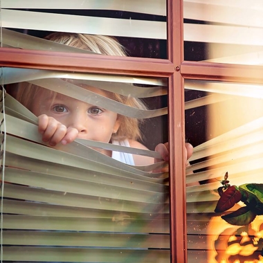 Child Looking Through Blinds.