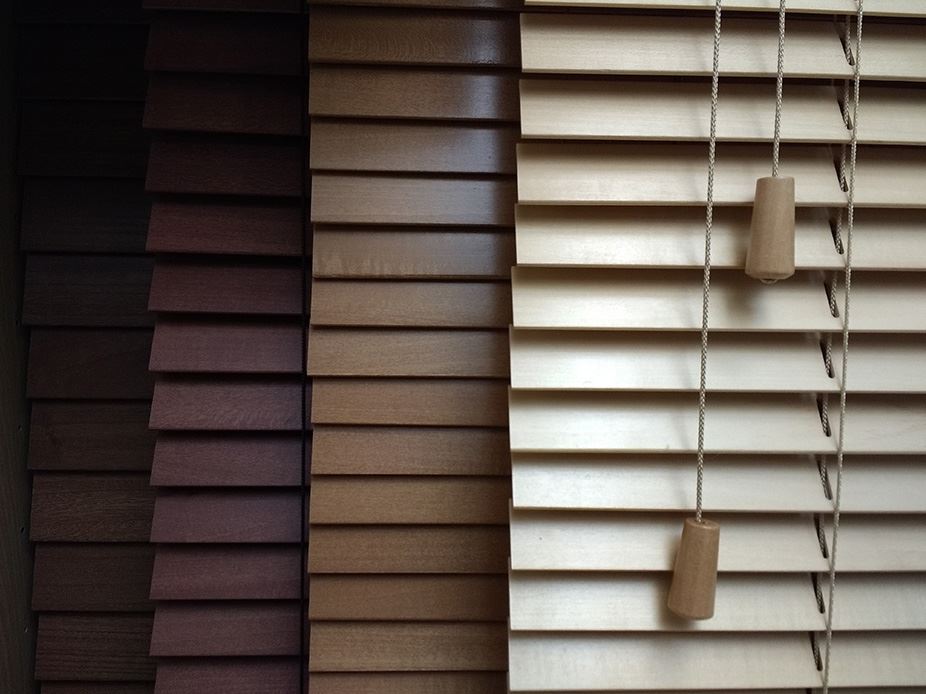 Different colors of wood blinds.